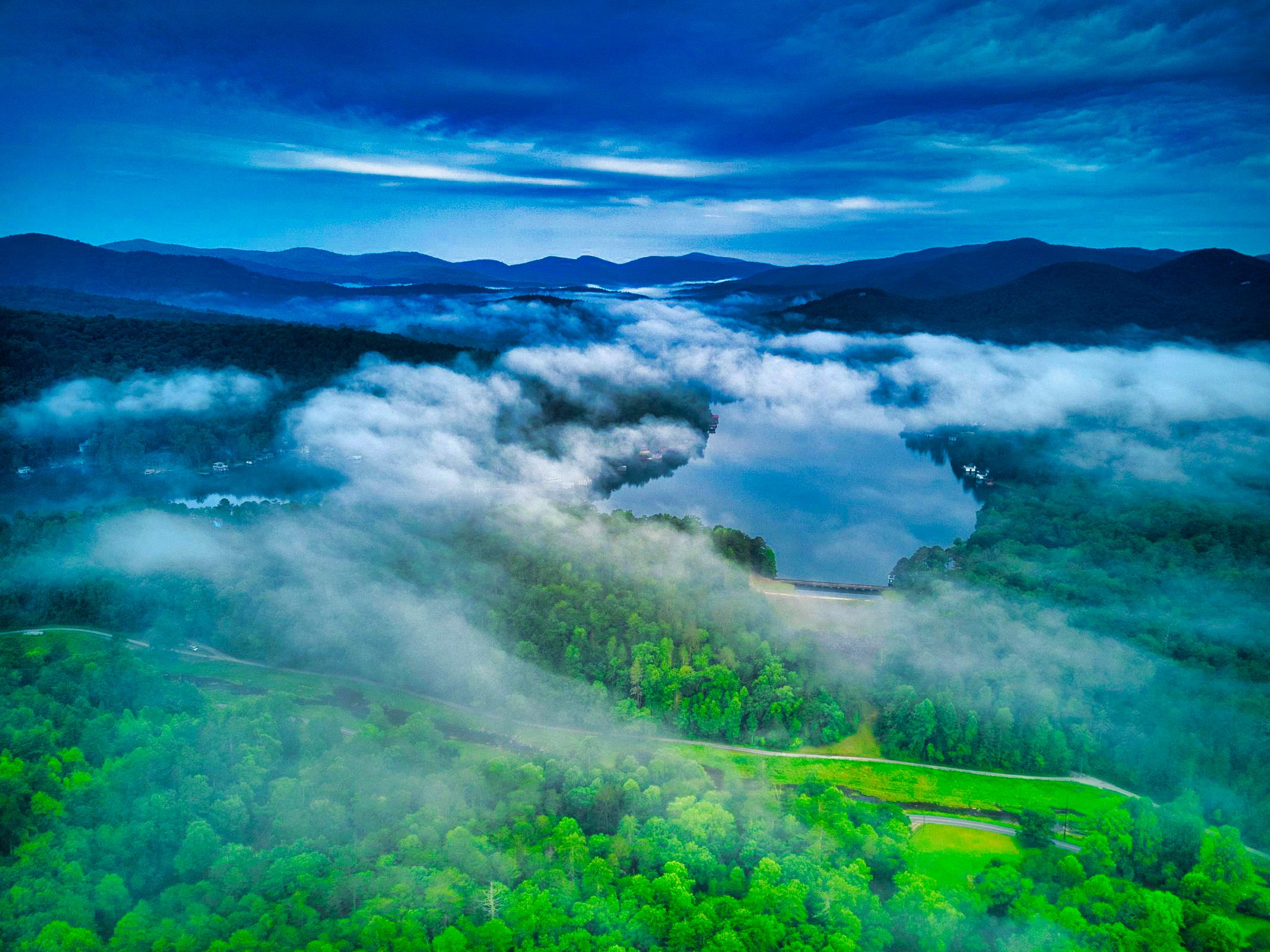 Misty mountain lake at dawn