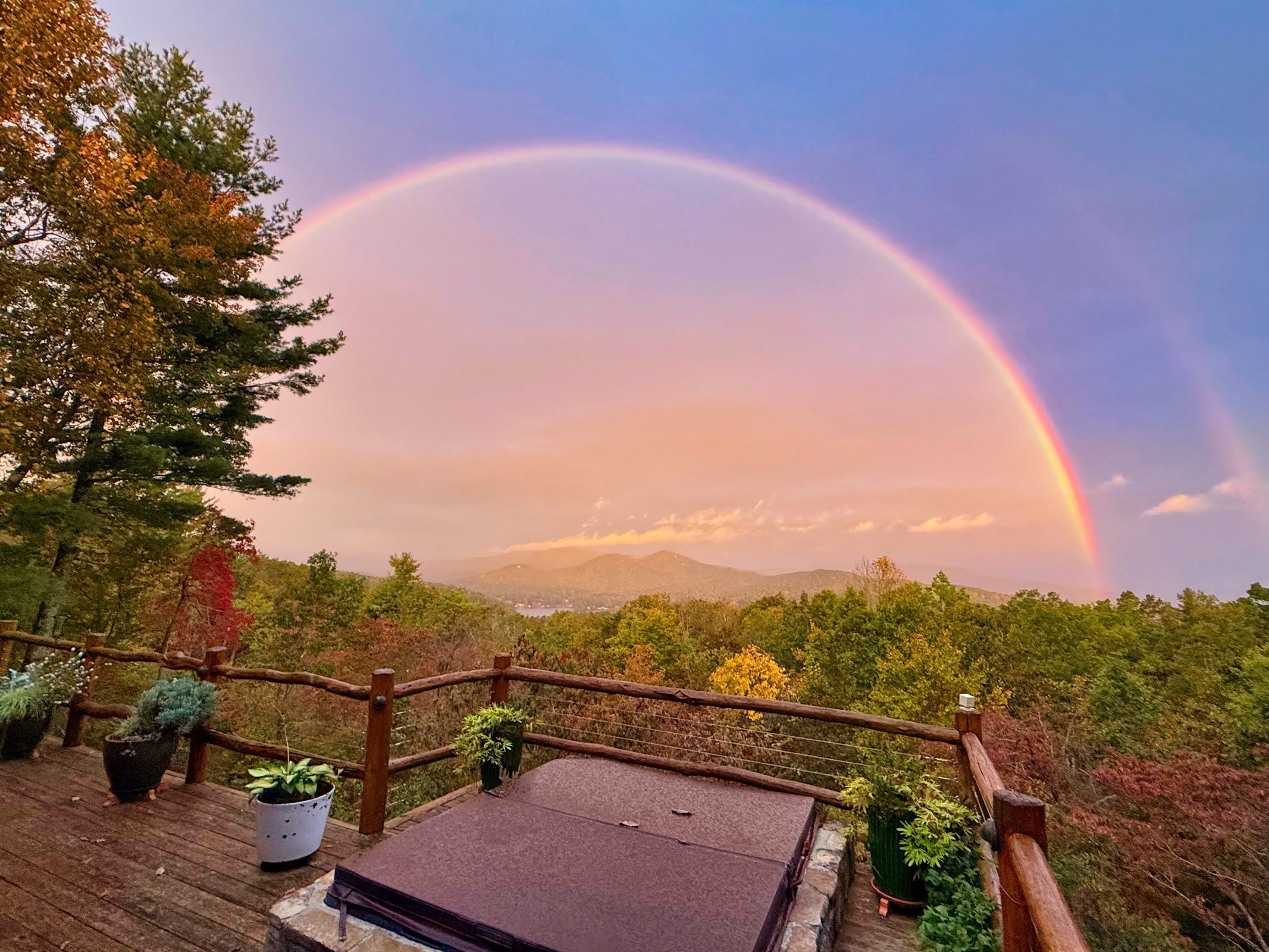 Double rainbow over mountain deck