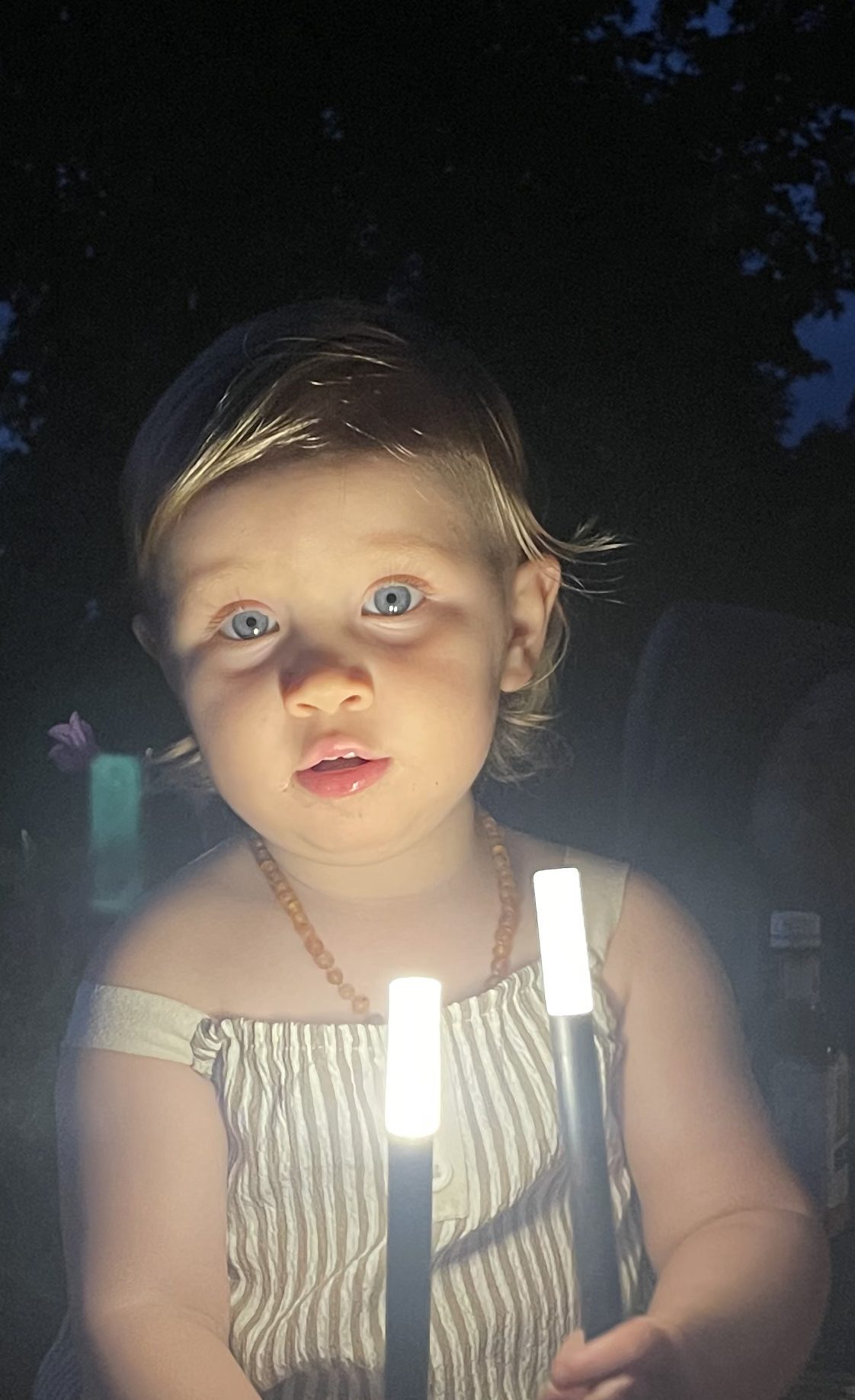 Child lit by lantern light
