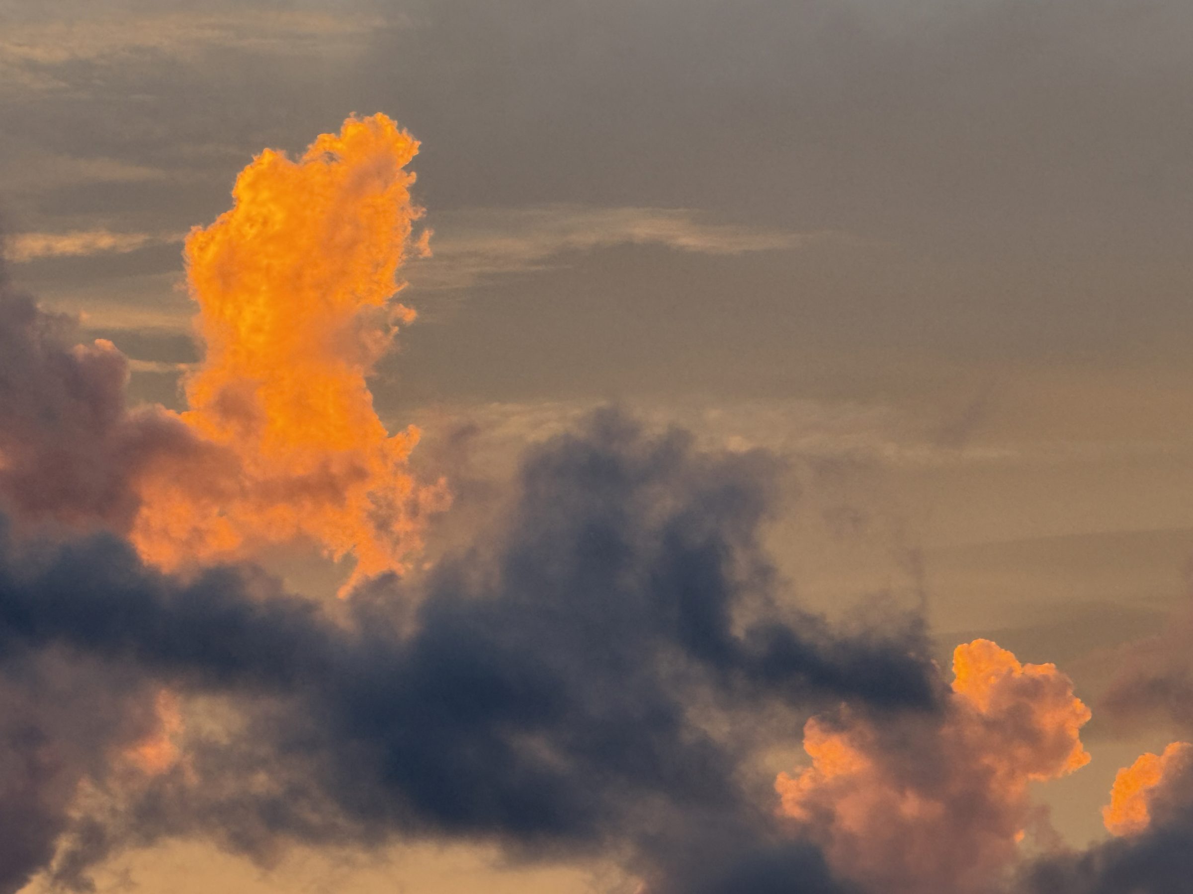 Storm clouds lit at golden hour