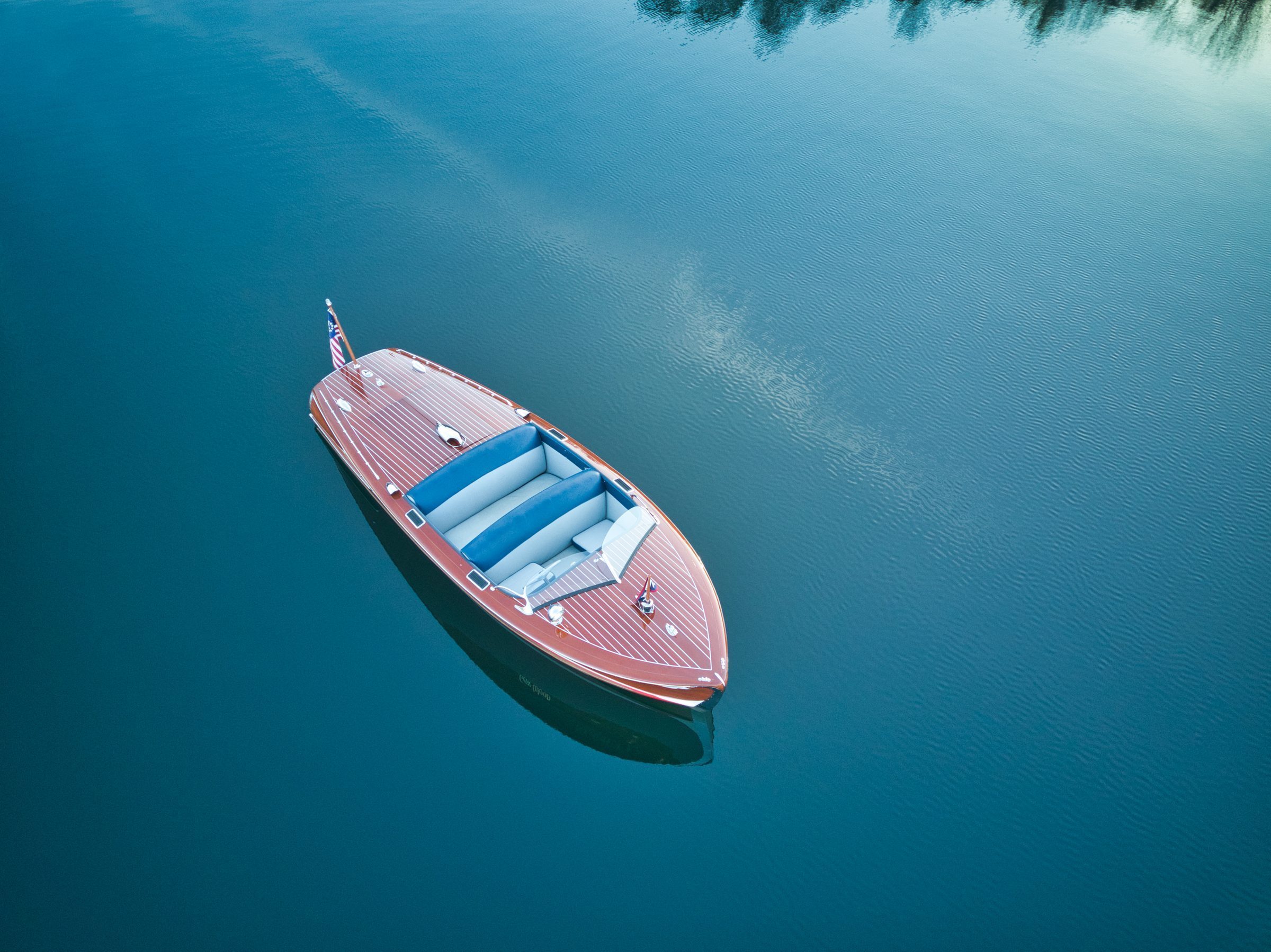 Gar Wood on glass-still teal water