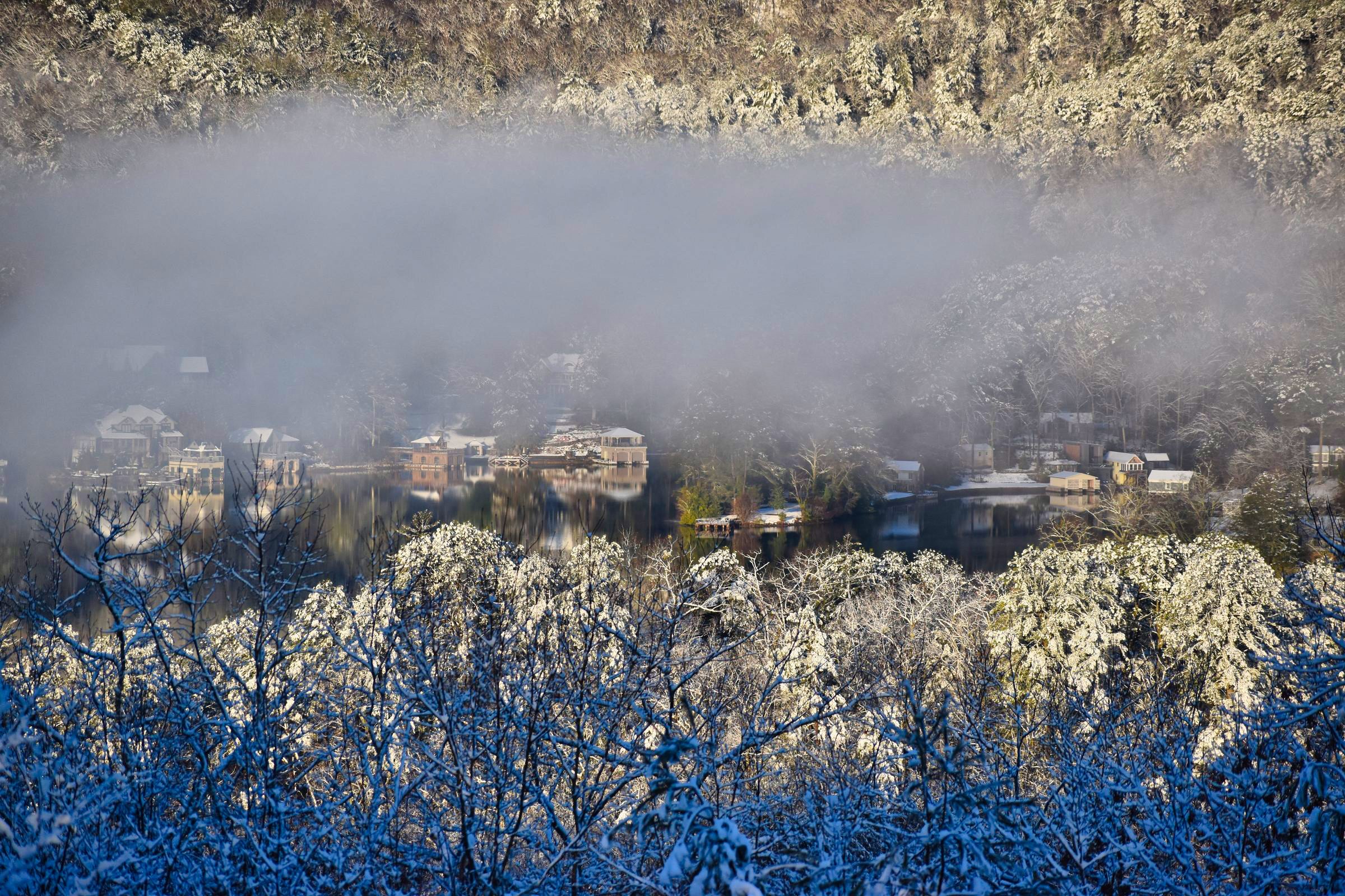 Snow-covered deck with mountain view