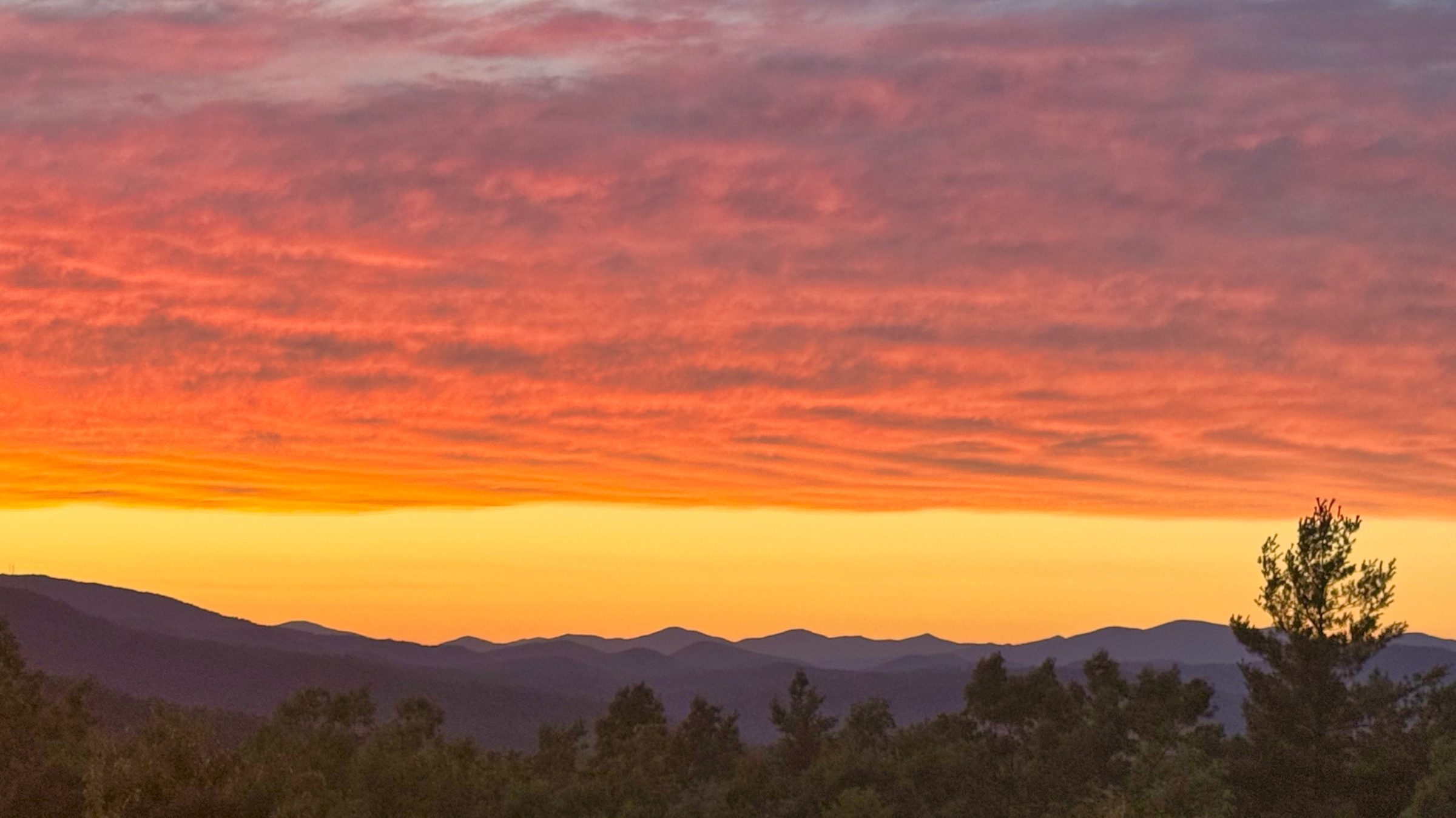 Fiery orange and red sunset sky over Blue Ridge mountain silhouette