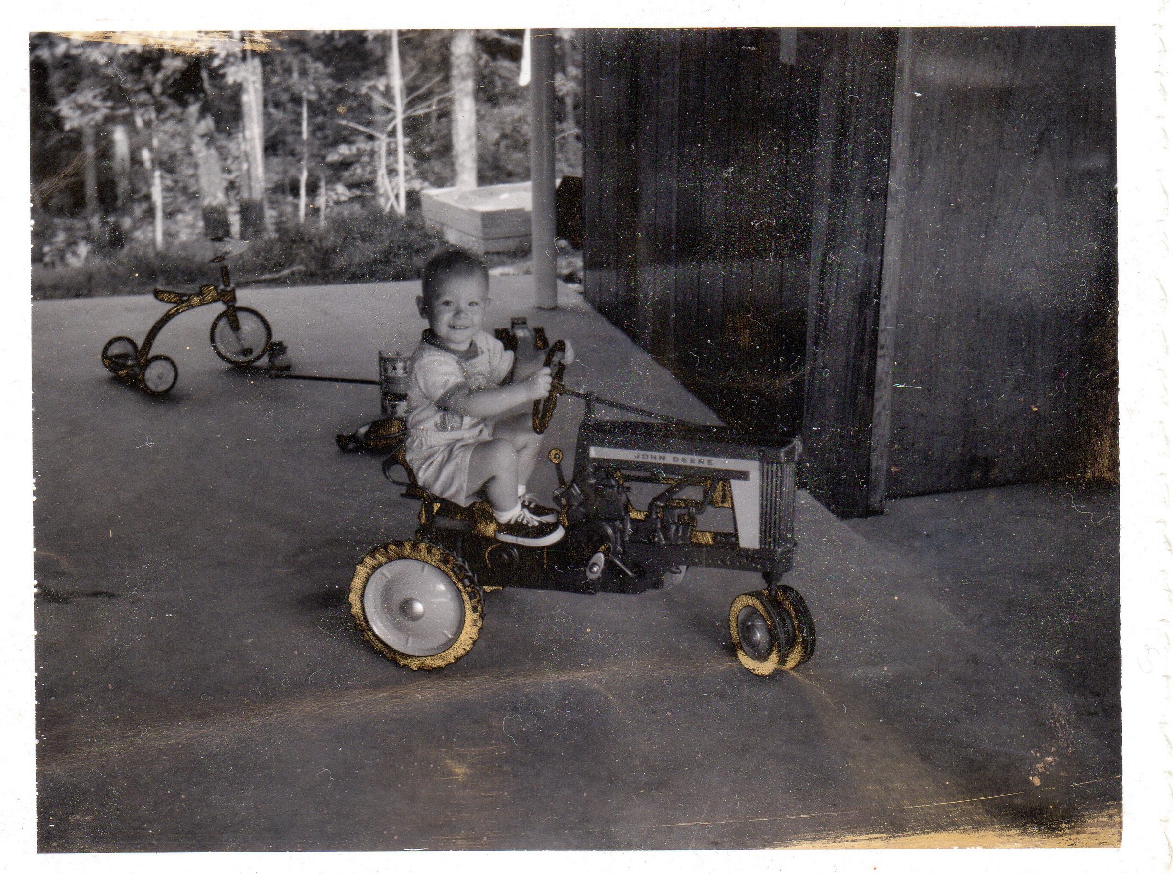 Young Van Thurston on a tractor — a vintage portrait